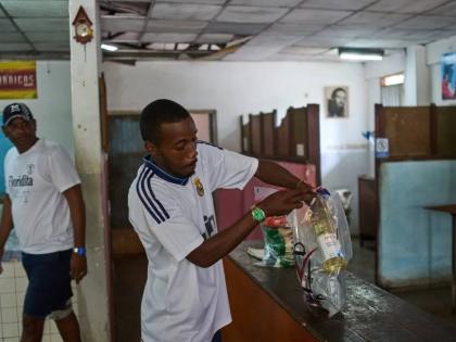 State-run bodega manager Roberto Roman fills bags with donated Mexican humanitarian assistance to be delivered to a family, in Havana, Cuba, Thursday, February 19, 2026.