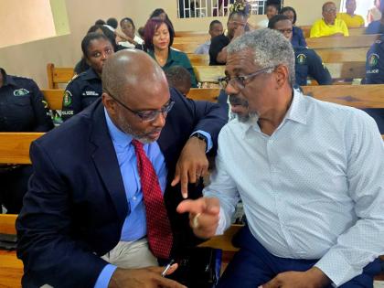 Dr Paul Hector (left) of UNESCO in conversation with Dr Patrick Prendergast, head of CARIMAC, during the More FM 14th anniversary church service, held on Sunday at the Duncans Evangelistic Centre in Trelawny.