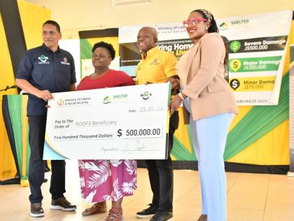 Minister of Labour and Social Security, Pearnel Charles Jr. (second right), presents a cheque to Hanover resident, Ena Campbell (second left), who lost her home during the passage of Hurricane Melissa last year. The occasion was the Hanover leg of the Rest