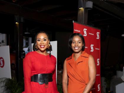  Krystal Tomlinson Carter (left), the evening’s emcee and founder of The Speakers’ Academy, shares a moment with Kimberly Gardner, public affairs and communications manager, Caribbean, North and Central, Scotiabank.