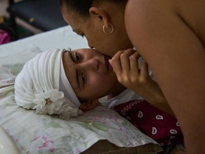 Niala Gonzalez, a cancer patient, is kissed by her mother at the National Institute of Oncology and Radiology in Havana, Cuba, Friday, February 20, 2026. 