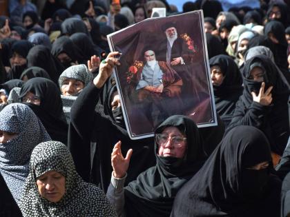 Shiite Muslims hold the portraits of Iranian leaders during a rally to condemn the killing of Iranian Supreme Leader Ayatollah Ali Khamenei, in Quetta, Pakistan on March 1, 2026. (AP Photo/Arshad Butt)