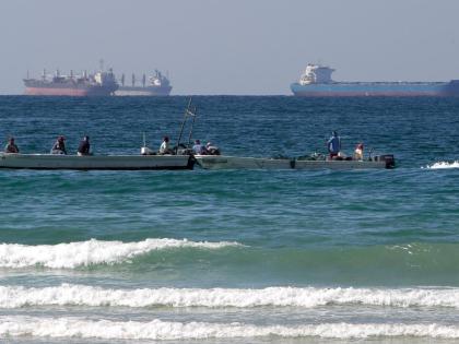 Fishermen work in front of oil tankers south of the Strait of Hormuz January 19, 2012, offshore the town of Ras Al Khaimah in United Arab Emirates. (AP Photo/Kamran Jebreili, File)