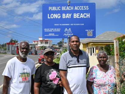 Regional Director, Jamaica Beach Birthright Environmental Movement (JABBEM), Wilbourn Carr (left), shares a moment with the grandchildren of the late Annie Neufville, Phyllis Byfield (second left), Winsome Walker (right) and great-grandson Chris Richards. 