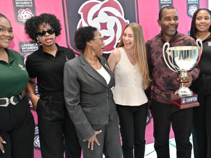Rudolph Speid, Reggae Boyz coach (second right) shows off thee the JWPL Cup during a chat with from left: Kajay Rowe, AVP, marketing and Innovation at Supreme Venture; Nardea Drummond, managing director of Acroscopic; Florette Blackwood, board member of th