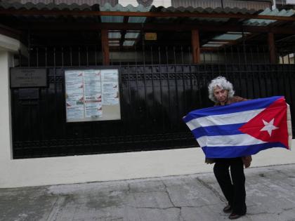 A woman holds up a Cuban flag outside the Cuban Embassy in Quito, Ecuador on March 4, 2026. (AP Photo/Dolores Ochoa)