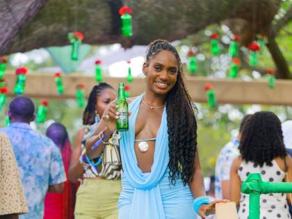 Dr Ashleigh Brown soaks up the sun and fun at the Heineken-sponsored Sunrise Breakfast Party in a plunging light blue maxi. 