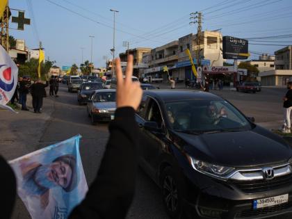 Displaced residents drive back to their villages as locals wave Hezbollah flags and an image of late Hezbollah leader Hassan Nasrallah, in Zefta, southern Lebanon, Friday, April 17, 2026, following a ceasefire between Israel and Hezbollah. (AP Photo/Hassan