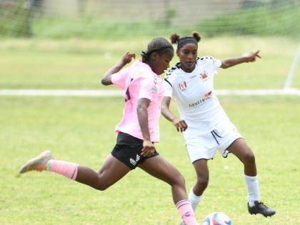 
Shennel Walters of Frazsiers Whip FC (left) gets ready to play the ball ahead of Adrianna Hall of Federal United FC during their Jamaica Women’s Premier League fixture at Excelsior High School yesterday. 