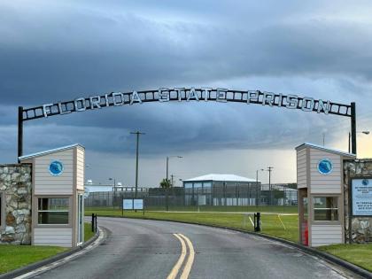 FILE - Clouds hover over the entrance of the Florida State Prison in Starke, Fla., Aug. 3, 2023. (AP Photo/Curt Anderson, File)