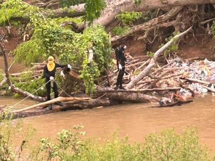 Divers at the scene where the body of a man who found floating in the Rio Cobre in a section of Spanish Town, St Catherine on April 30.