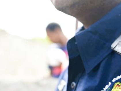 A member of the JCF is seen wearing a body-worn camera.