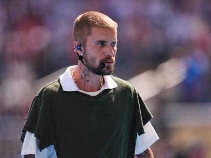 Justin Bieber leaves the pitch after performing at halftime during the World Cup final soccer match between Spain and Argentina on Sunday.