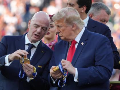 FIFA President Gianni Infantino, left, and President Donald Trump comment on the medals as they wait to congratulate the Spanish players after the World Cup final soccer match between Spain and Argentina in East Rutherford, N.J., near New York, Sunday, Jul