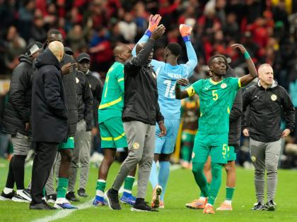 FILE – Senegal’s Idrissa Gueye (right) calls players to walk off the pitch during the Africa Cup of Nations final between Senegal and Morocco, in Rabat, Morocco, Sunday, January 18, 2026. 