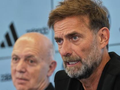 Newly appointed head coach of the German national football team Juergen Klopp (right) at a news conference at the headquarters of the German Football Association DFB in Frankfurt, Germany yesterday.