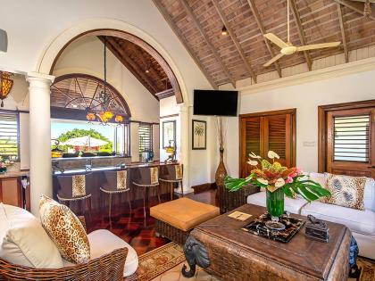 The wet bar serves both indoor and outdoor living spaces. 