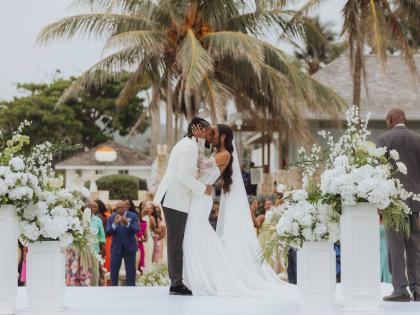 Noel and Krisann seal their nuptials with a kiss at the altar.