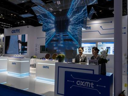 FILE - Workers at the booth for Chinese DRAM producer ChangXin Memory Technologies, also known as CXMT, wait for visitors at the 21st China International Semiconductor Expo in Beijing, Nov. 20, 2024. (AP Photo/Ng Han Guan, File)