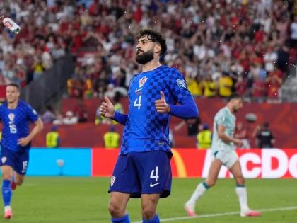 A beer can flies through the air near Croatia’s Josko Gvardiol (4) during the World Cup round-of-32 football match against Portugal in Toronto, Thursday, July 2.