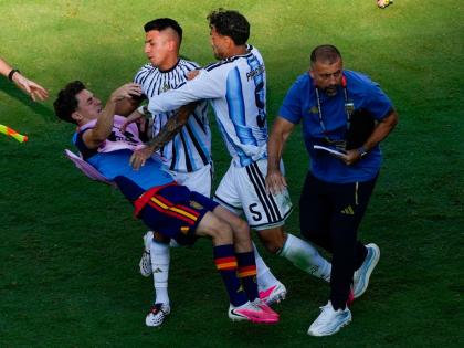 Spain's Gavi, left, falls as he scuffles with Argentina's Leandro Paredes (5) and Thiago Almada during the World Cup final soccer match between Spain and Argentina in East Rutherford, N.J., near New York, Sunday, July 19, 2026. (AP Photo/Yuki Iwamura)