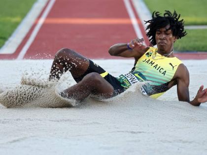 Jamaica’s Michael-Andre Edwards hits the sandpit during the triple-jump final at the World Athletics Under-20 Championships at the Hayward Field in Eugene, Oregon.