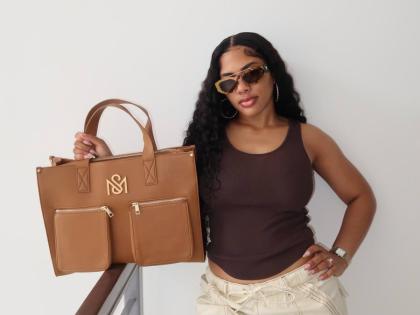 Shacqueal Major, founder of SM Kollection, carries the brand’s signature tote in tan.
