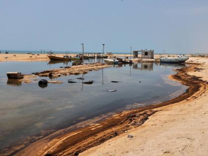 
Oil residue lines the shore near fishing boats on Qeshm Island, Iran, amid ongoing wartime attacks on vessels and infrastructure in and around the Strait of Hormuz, though the spill’s source has not been independently determined.