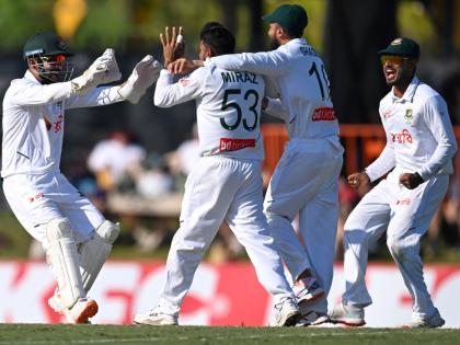 
Mehidy Hasan Miraz (centre) of Bangladesh is congratulated by teammates after taking the wicket of Australia’s Steve Smith during play on day three of the first cricket Test in Darwin, Australia, yesterday.