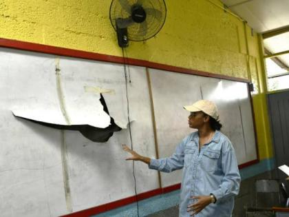 Minister of State in the Ministry of Education, Skills, Youth and Information, Rhoda Moy Crawford, shows one of the damaged whiteboards at Albert Town Primary and Infant School in Trelawny, which will be replaced as part of repairs now taking place at the 