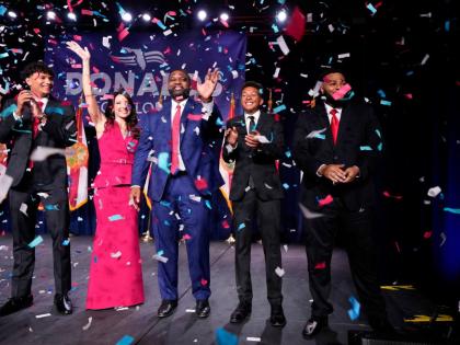 Florida Republican gubernatorial candidate Byron Donalds (center) waves next to his wife Erika, while standing on stage with their children Darin (left), Damon (second from left), and Mason at a primary election party on Tuesday in Orlando, Florida, United