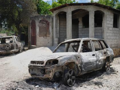 Vehicles that were set on fire by armed gangs sit in the Cite Soleil neighborhood of Port-au-Prince, Haiti, May 12.