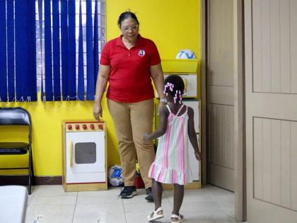 A practitioner observes a child during an Ages and Stages Questionnaire-Jamaica (ASQ-J) screening session at the Caenwood Resource Centre in St Andrew. 