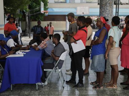 Haitians register to vote in the upcoming general election in Port-au-Prince, Haiti, Friday, July 31, 2026. (AP Photo/Odelyn Joseph)
