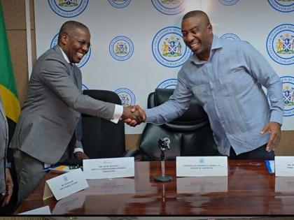 Mayor of Kingston, Andrew Swaby (right) and Dave Jeffery, Deputy Commissioner General – Operation at Tax Administration Jamaica at a press conference about bringing tax and fee compliance services to business and property owners in Half-Way Tree, St Andr