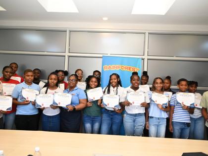 Primary, secondary and tertiary students, all children of Rainforest employees, pose for a photograph after receiving certificates during an awards presentation at Rainforest’s headquarters in Montego Bay on Tuesday. 