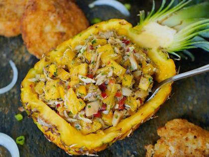 A vibrant salt fish salsa served in a cored pineapple. 
