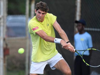 Blaise Bicknell plays a two-handed backhand during his Kingston Open round-of-32 game against Max Purcell at the Liguanea Club on Tuesday.