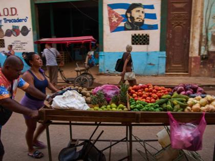 Street vendors push their cart of vegetables past a mural of Fidel Castro in Havana, Cuba, August 12.