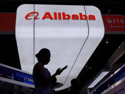 A visitor walks in front of Alibaba’s booth during the 3rd China International Supply Chain Expo at the China International Exhibition Center in Beijing, China, in July 2025.  AP