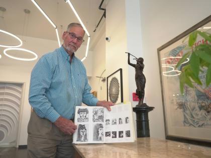 Art dealer Bill DeLind shows a picture of a Pablo Picasso sketch (upper left) stolen from his shop DeLind Fine Art Appraisals in 2018 in Milwaukee on Aug. 14, 2026. The sketch was recently found in town. 