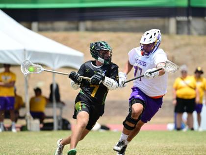 Jamaica’s Elias McLaughlin (left) battles with Logan Lee of Haudenosaunee during yesterday’s bronze medal match at the Stadium East field.