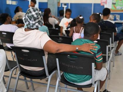 Parents and students wait at the Morant Bay Health Centre to access medical examinations and other services during the St Thomas Health Department's Back-to-School and Vaccination Drive on Saturday.