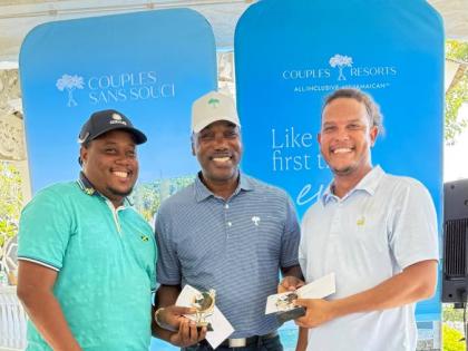 Gary Holgate (centre), general manager, Couples Tower Isle, presents Oshane Haye (left) and Zandre Roye with prizes for winning first-place gross with a score of 61 at Sunday’s annual Couples Resorts Ocho Rios Charity Golf Tournament held at the Sandals 