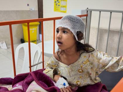 A child wounded, according to Tasnim news agency, in a strike on a home where a wedding was being held in Kuhestak, southern Iran, receives treatment at a hospital in Menab, Iran, early Wednesday.