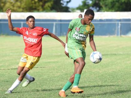 Ocho Rios High’s Dario James (right)  tries to outrun Old Harbour High’s  Dimell White during their opening match of the ISSA Ben Francis Cup KO round one match at Drax Hall Sports Complex  on Friday, December 12, 2025.