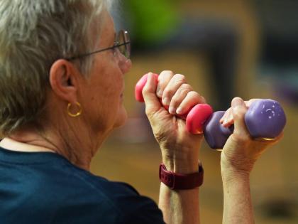 A participant uses light weights during a class for older adults at the Dale Turner Family YMCA in Shoreline, Washington, on April 30.