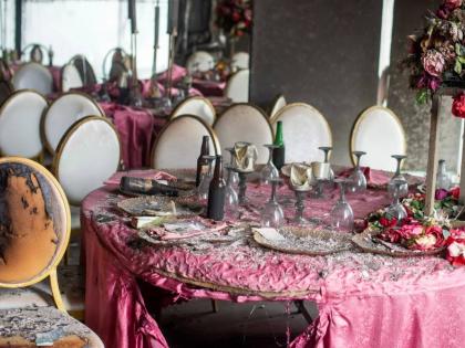 Tablescapes are covered in ash and debris in the aftermath of a fire that broke out in a building hosting a wedding party in Lingwala, Congo, Saturday, September 5, 2026. (AP Photo/Guylain Kipoke) 