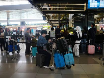 Travelers wait for their flights at Soekarno-Hatta International Airport in Tangerang, Indonesia.
