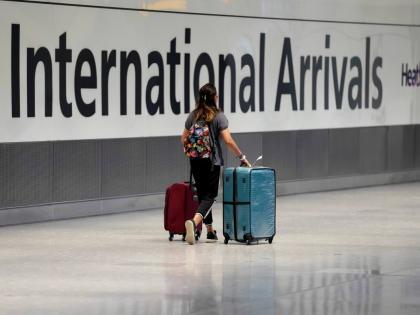 FILE - A passenger arrives from a flight at Terminal 5 of Heathrow Airport in London, August 2, 2021. (AP Photo/Matt Dunham, File)